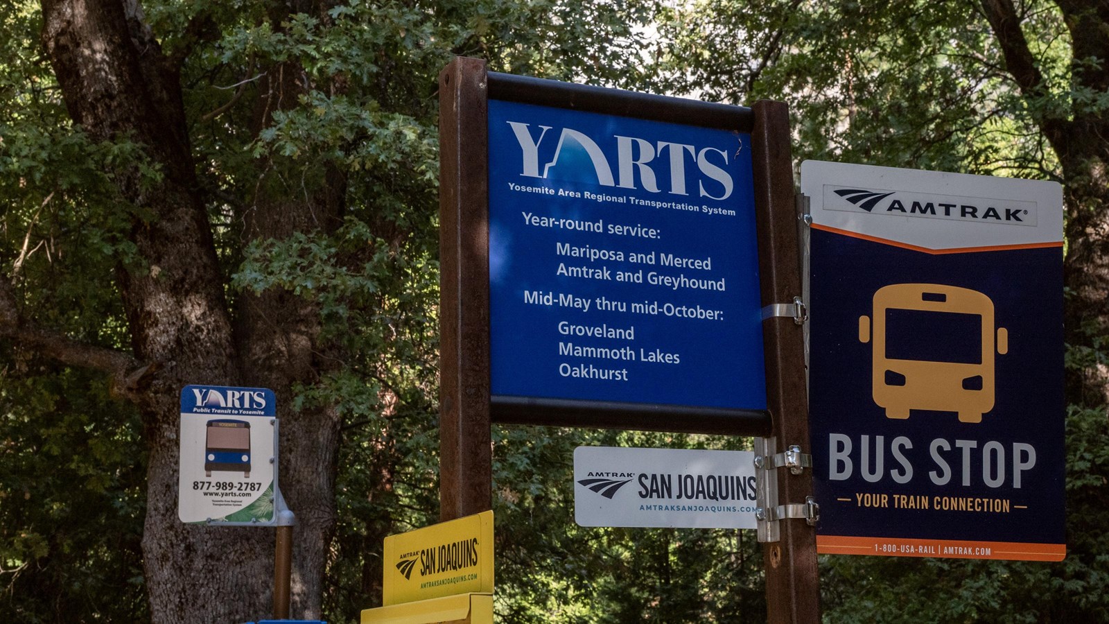 Several transit signs on multiple metal posts