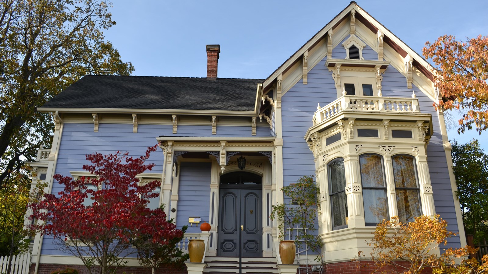 Photo of two and a half story blue house. 