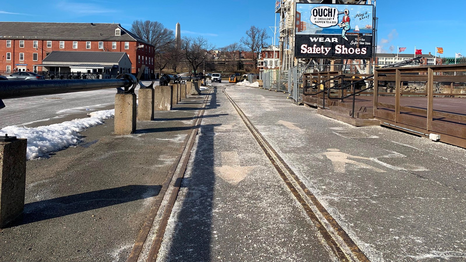 Railroad tracks through the yard, paved over with asphalt so the tracks are still visible in ground.