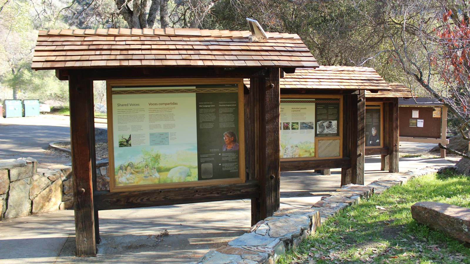 Three free-standing, wood exhibit panels and a bulletin board are found on the picnic area sidewalk.