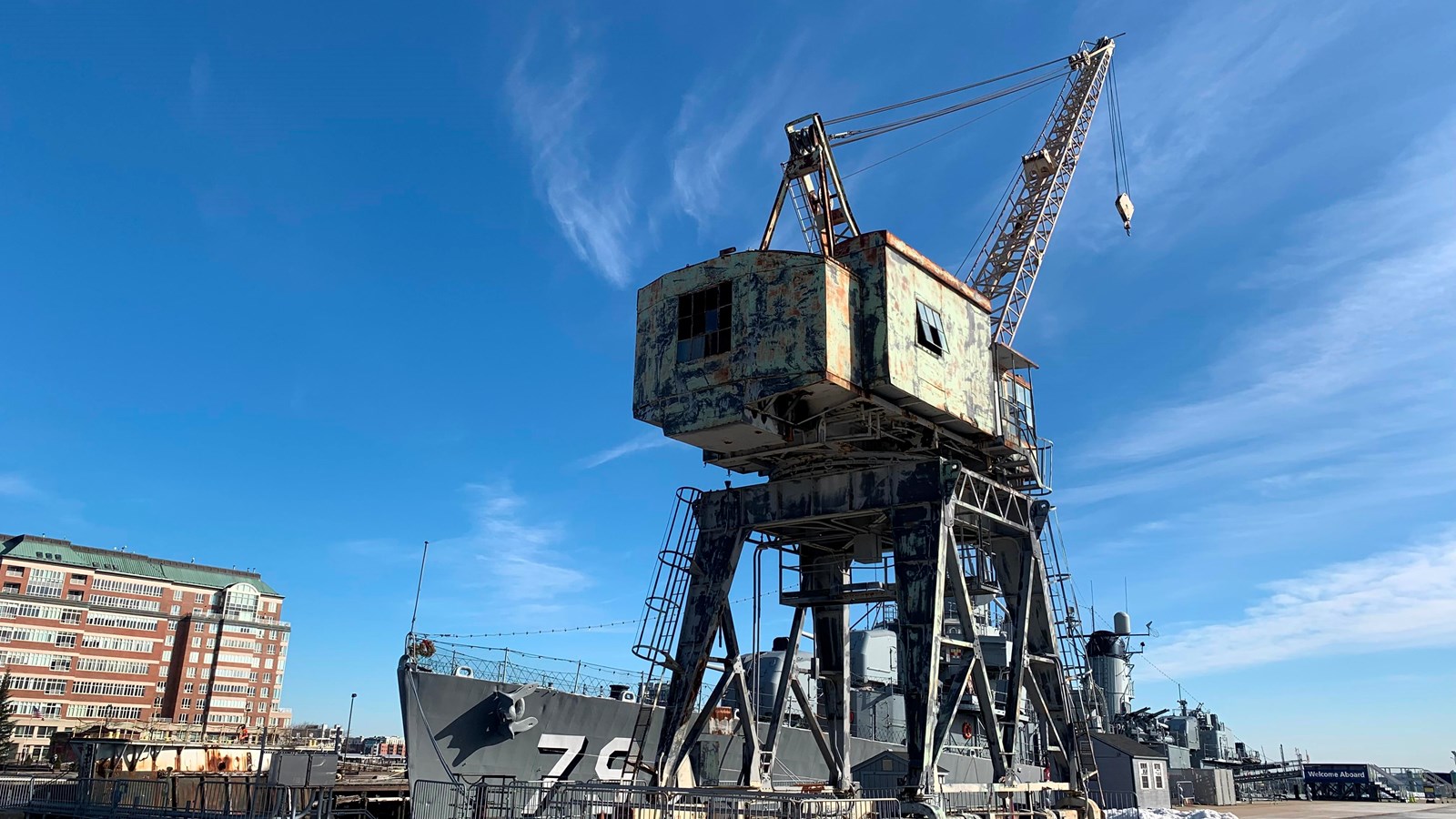 Portal Crane with four metal legs that raise up to a square structure. Crane rises from structure.
