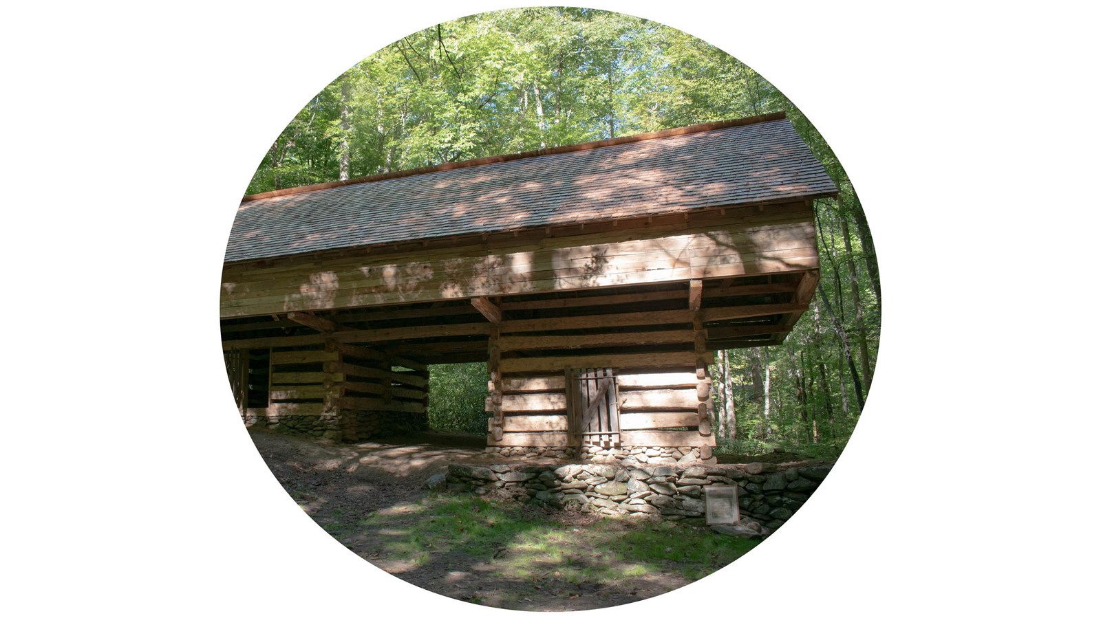 A photo of a cantilever barn in the woods.