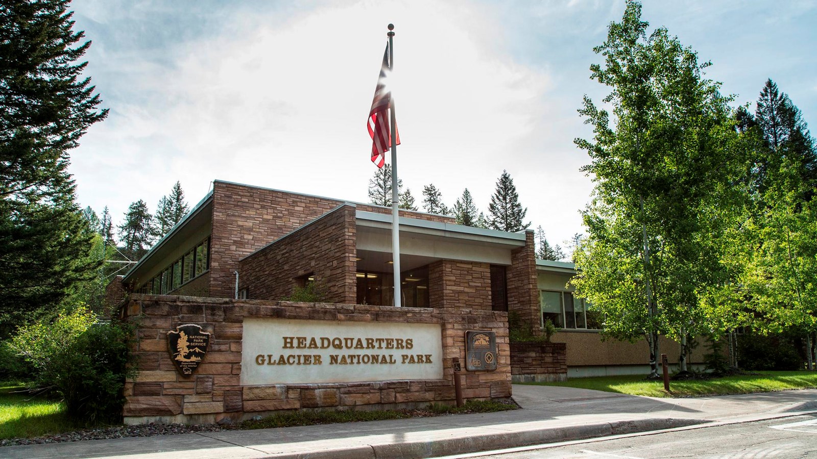A brick building with an American flag and sign that says 