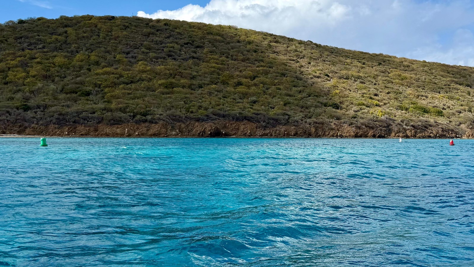 Water with two markers indicating the entrance with Buck Island in the distance