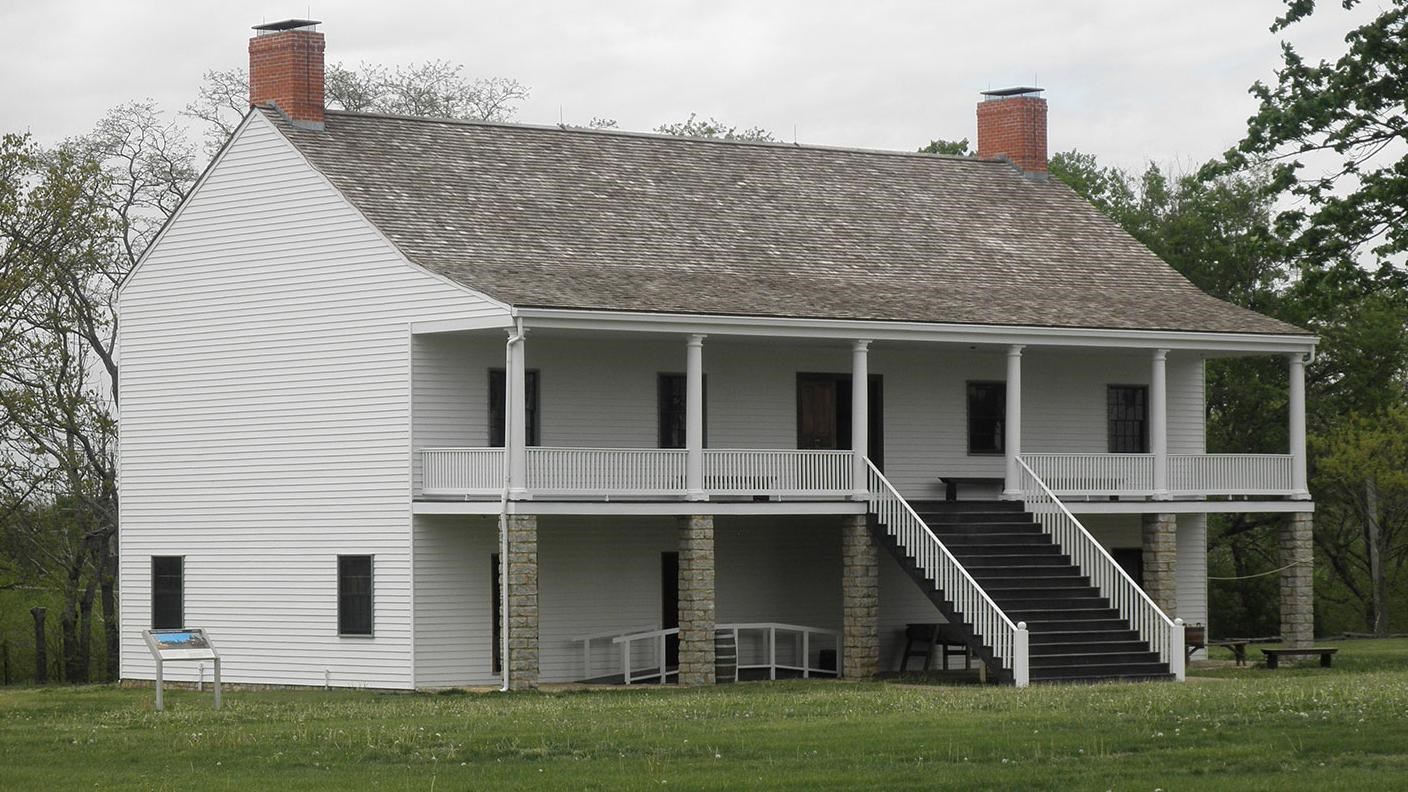 two story building with stairs in the middle and fireplaces on each end