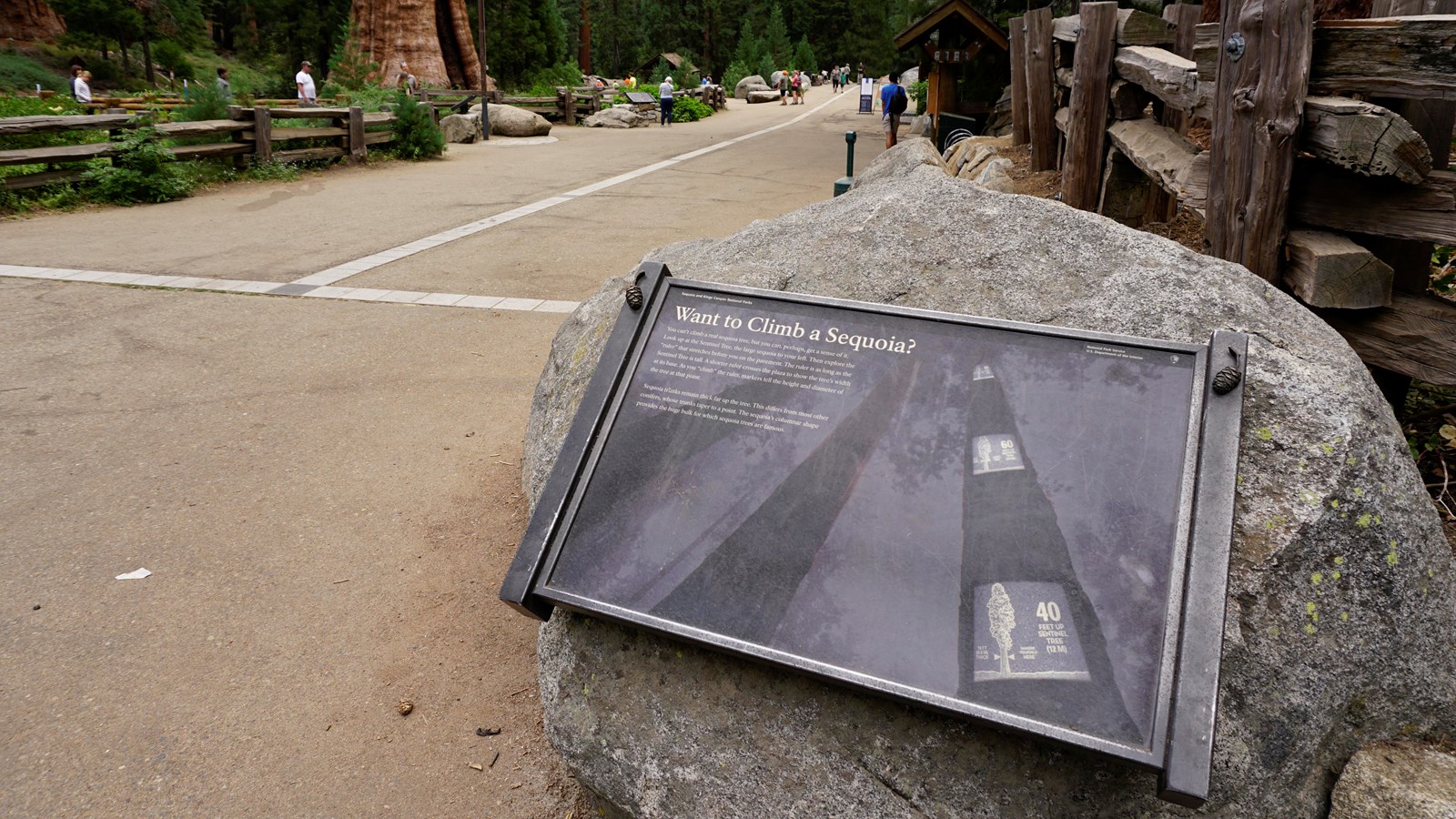 A metal panel is bolted to a granite rock