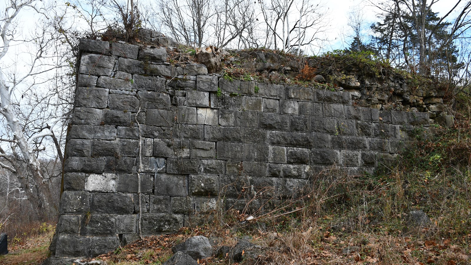 The remains of a bridge abutment is made of limestone blocks. 