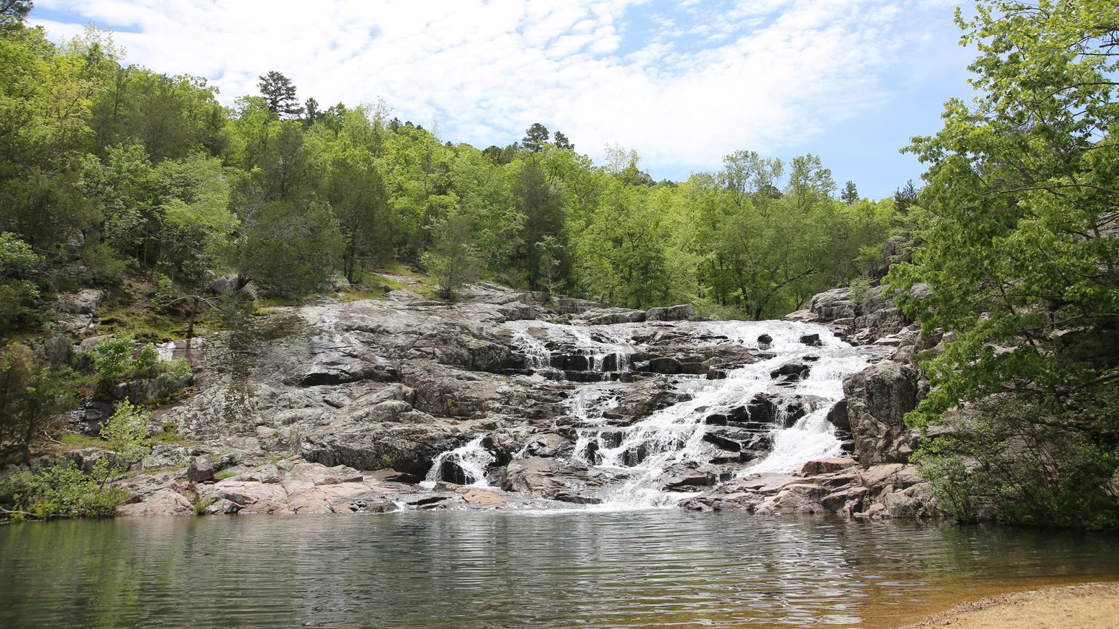 A rocky shut-in with rushing waters, flanked by green trees on either side.