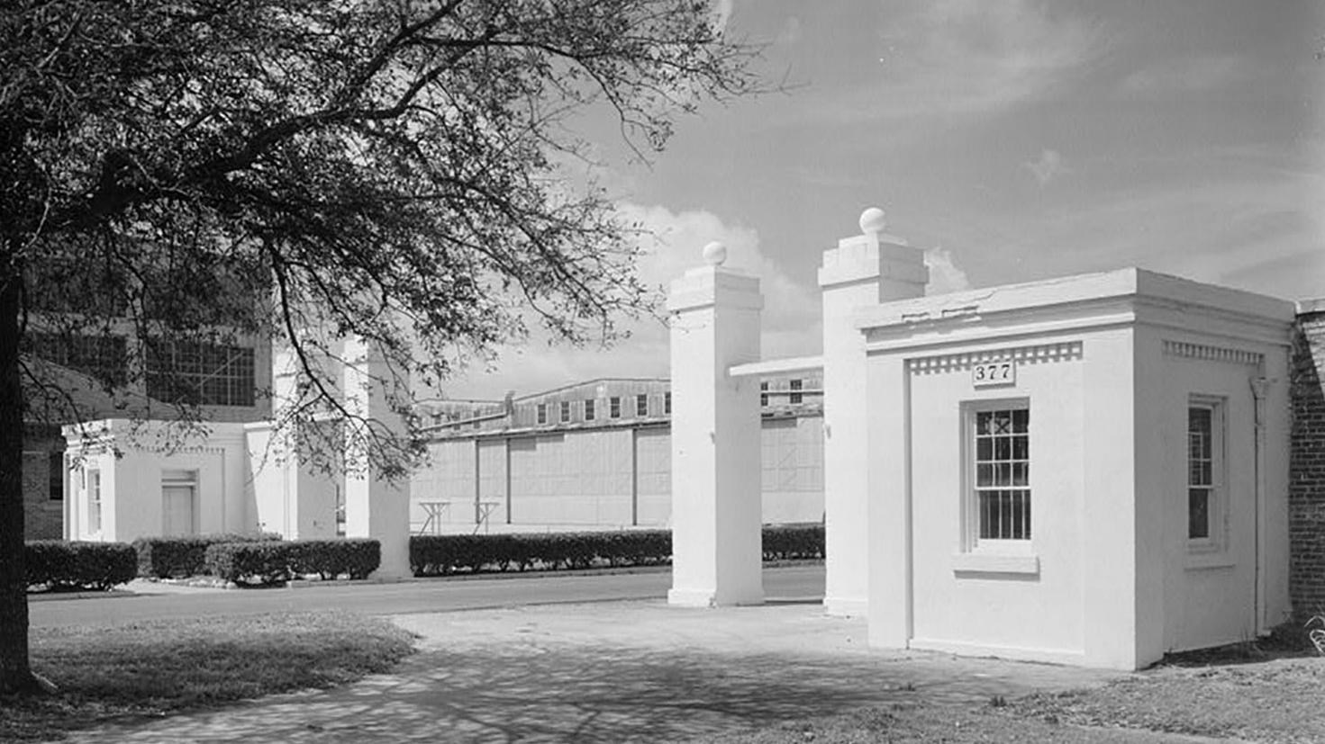 White brick columns and gatehouse entry to naval station