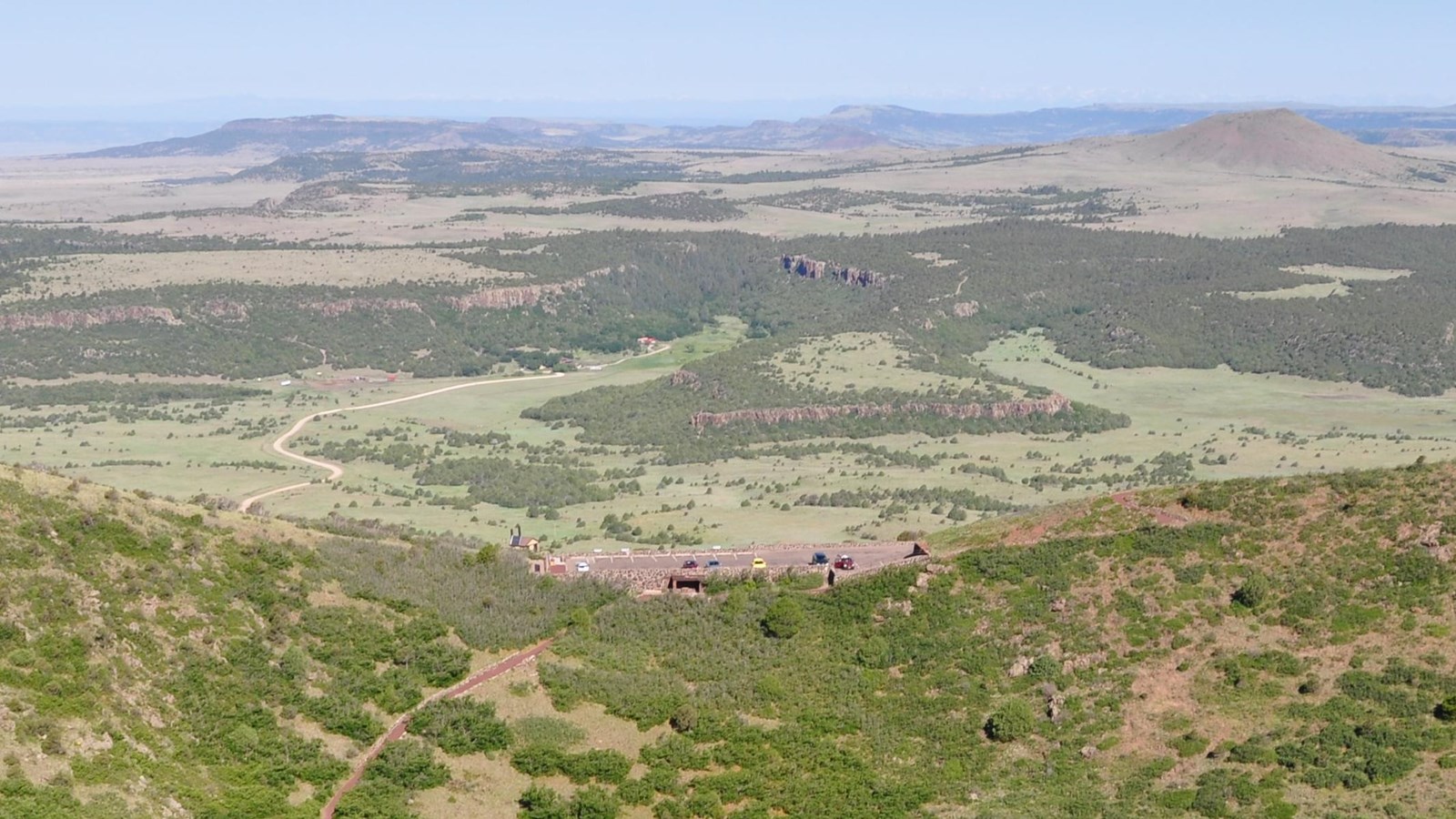 green view of the crater, parking area, and other volcanoes from the top of Capulin Volcano