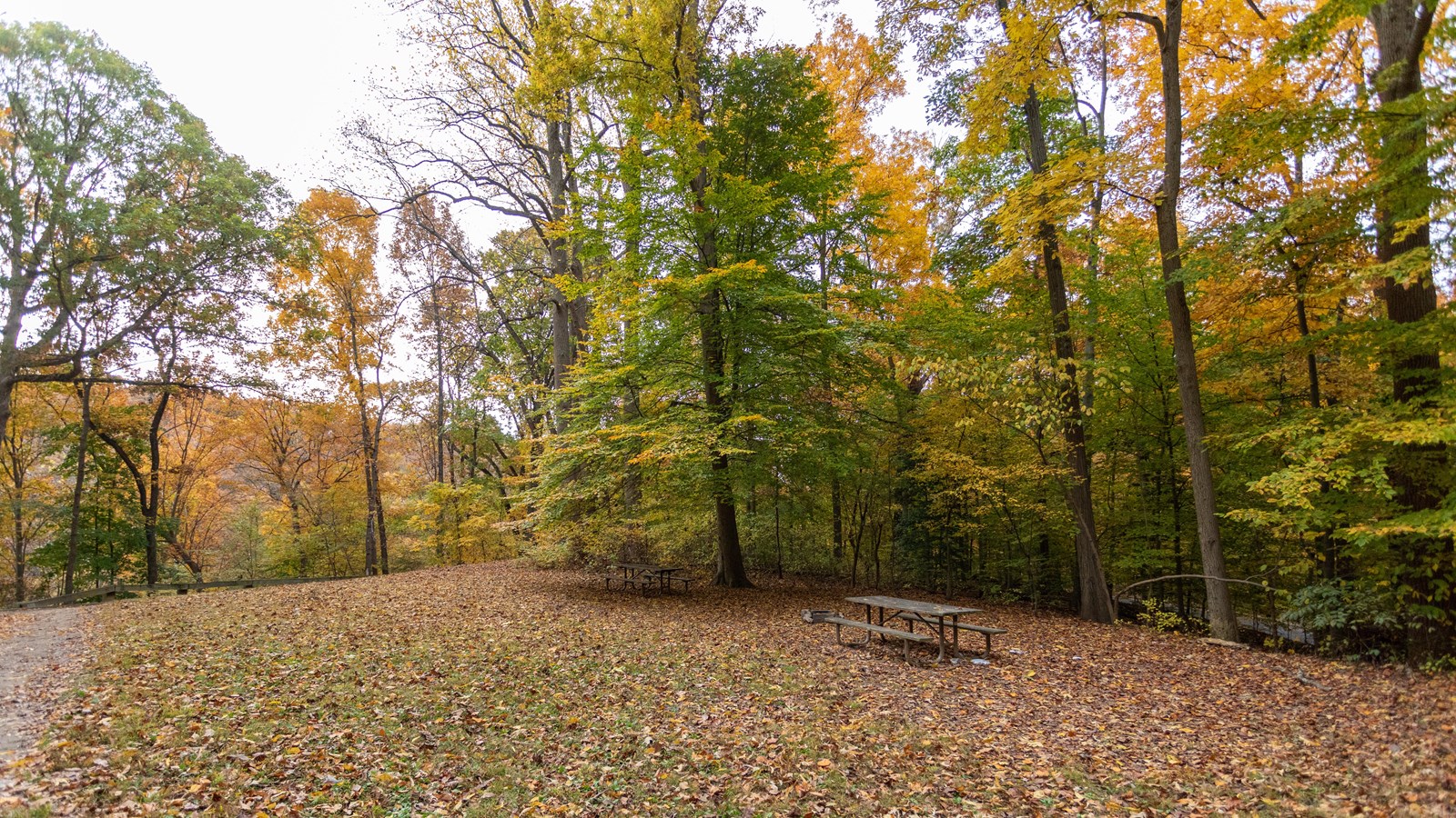 A picnic bench in a large field. 