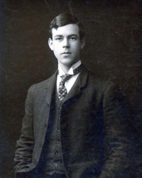 Man in suit poses for picture