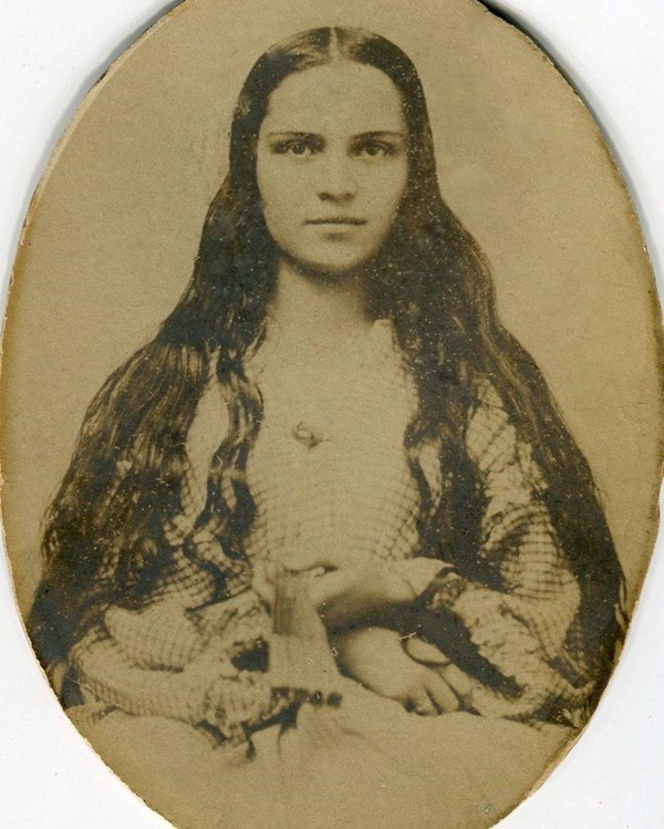 Historic image of woman sitting for a photograph