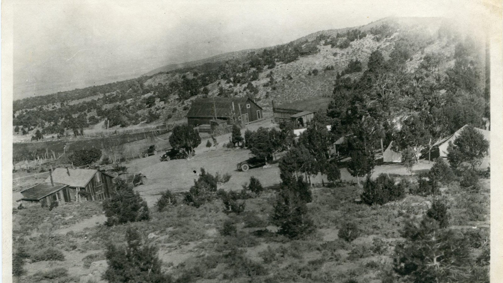 A sepia, historic photograph of the area immediately surrounding lehman caves, showing old buildings