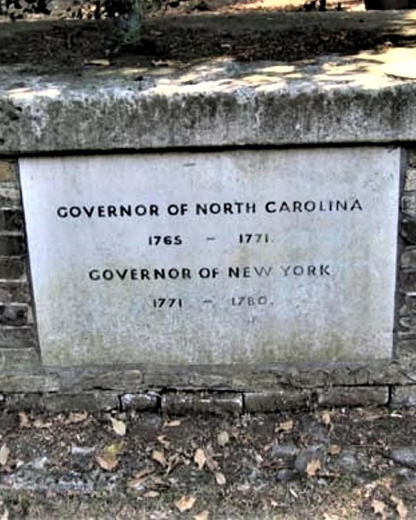 A brick structure about the size of a bike rack. With lettering etched on the front.