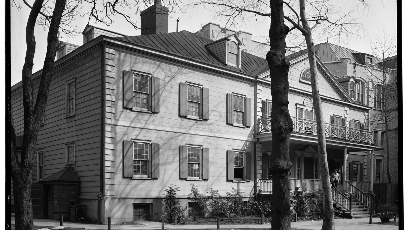 Exterior front of a two-story building with trees. Historic American Buildings Survey.