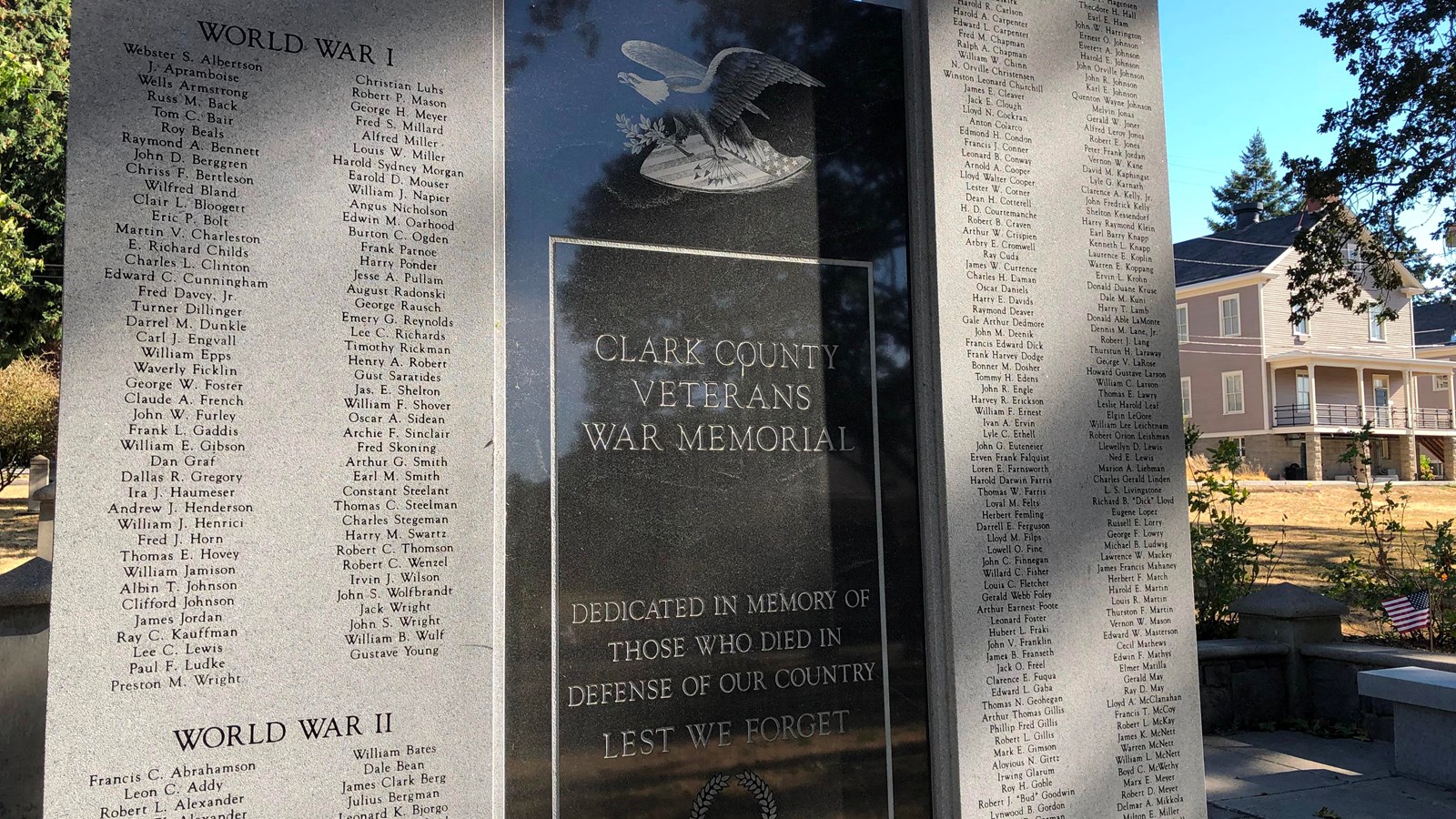 A stone monument with engravings of an eagle and names of servicemen and women.