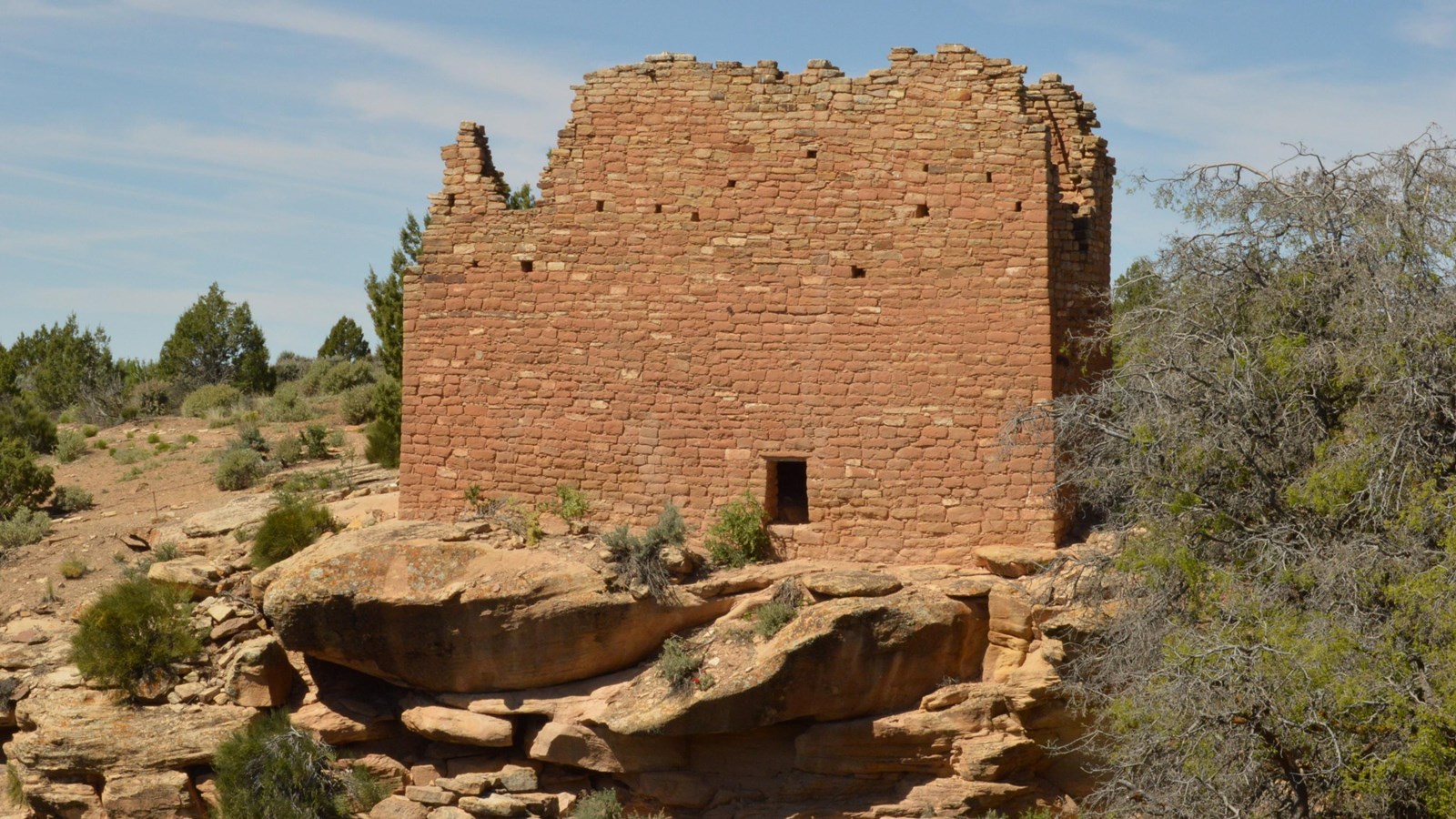 a tall, rectangular stone structure perched on the canyon rim