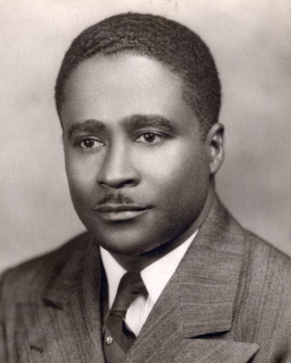 Young African American man in tan suit
