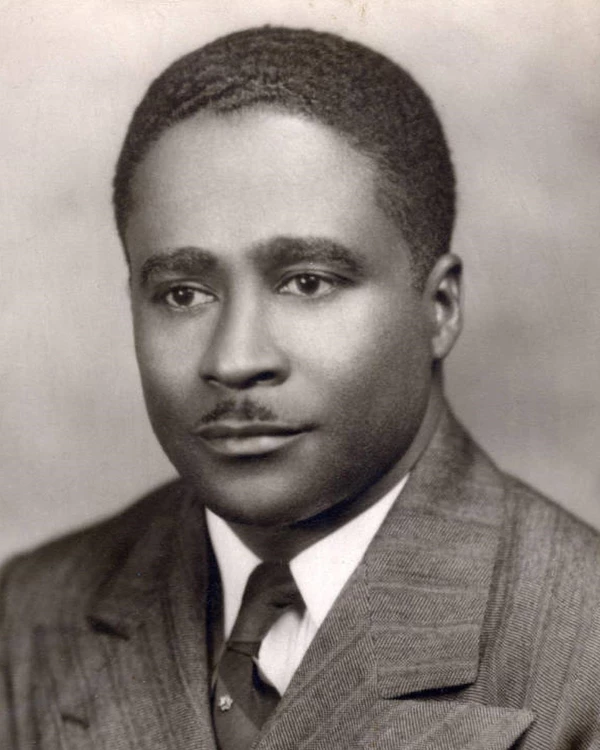 Young African American man in tan suit