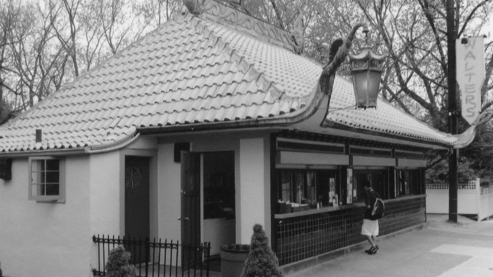 Roadside food stand with a prominent steeply pitched roof clad with copper tiles