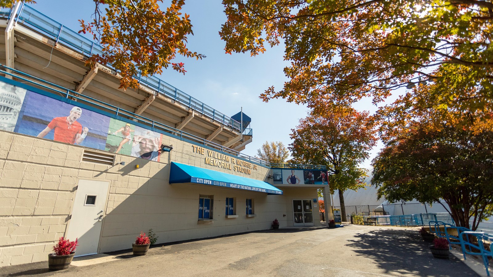 A large building leading to tennis courts.