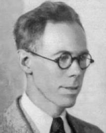 Man in suit and glasses poses for picture