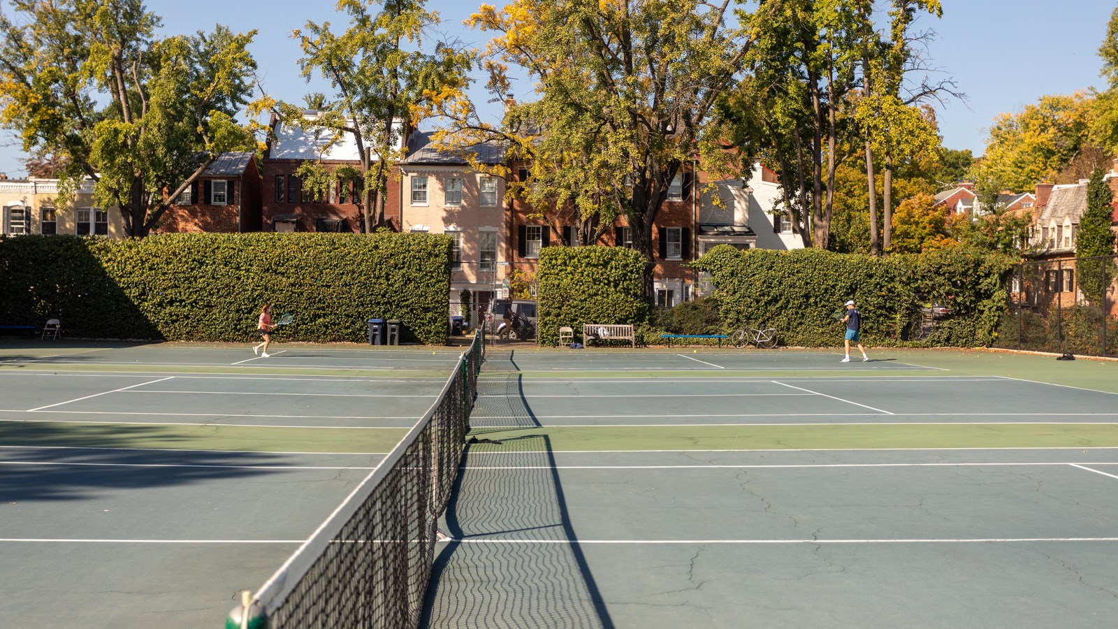 Two tennis courts with a net between each side.
