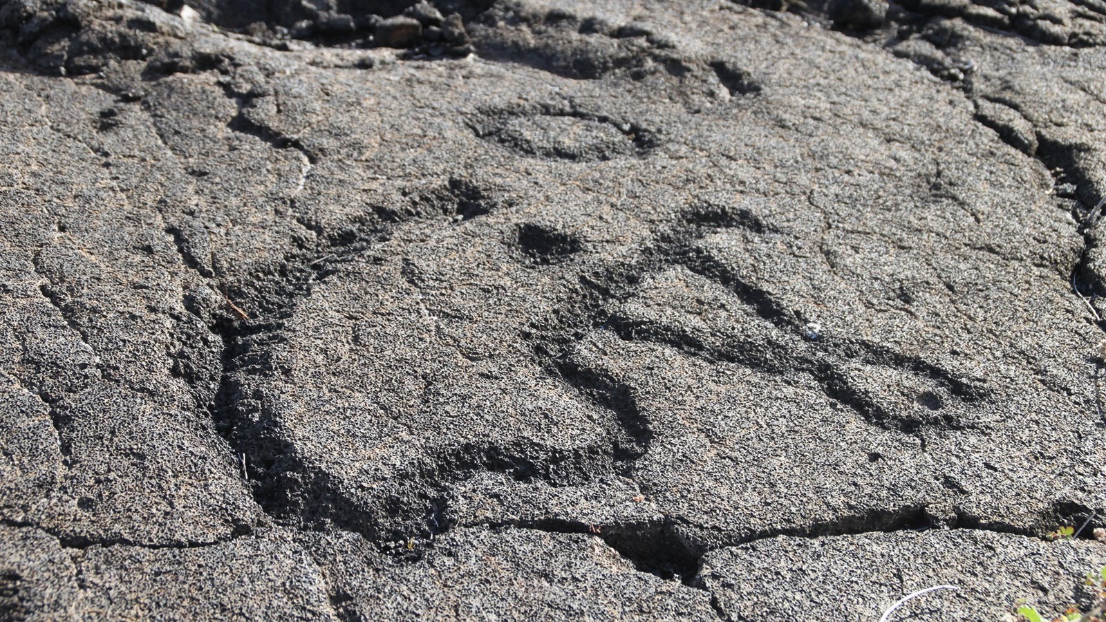 Petroglyph in gray rock of a human figure 