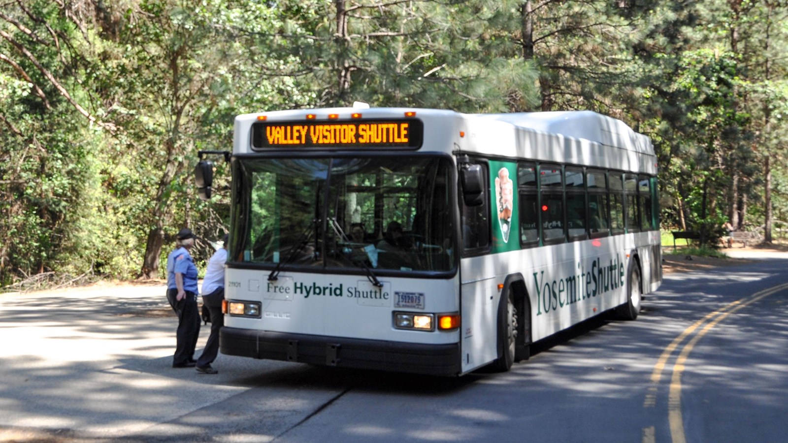 Shuttle bus with people at stop