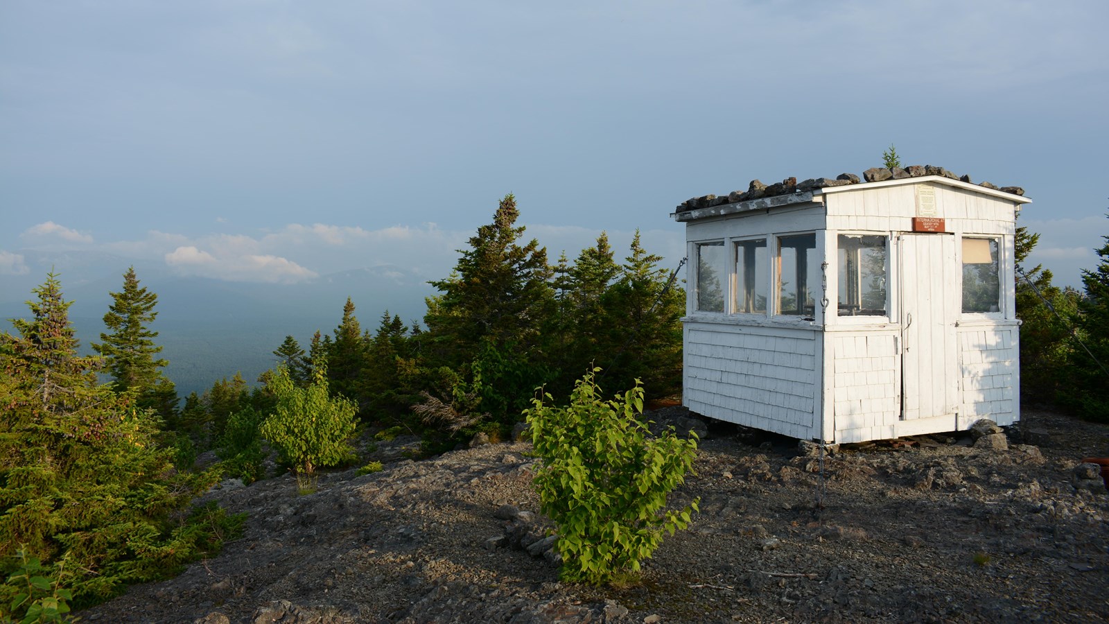 One room fire lookout surrounded by subalpine vegetation and spruce.