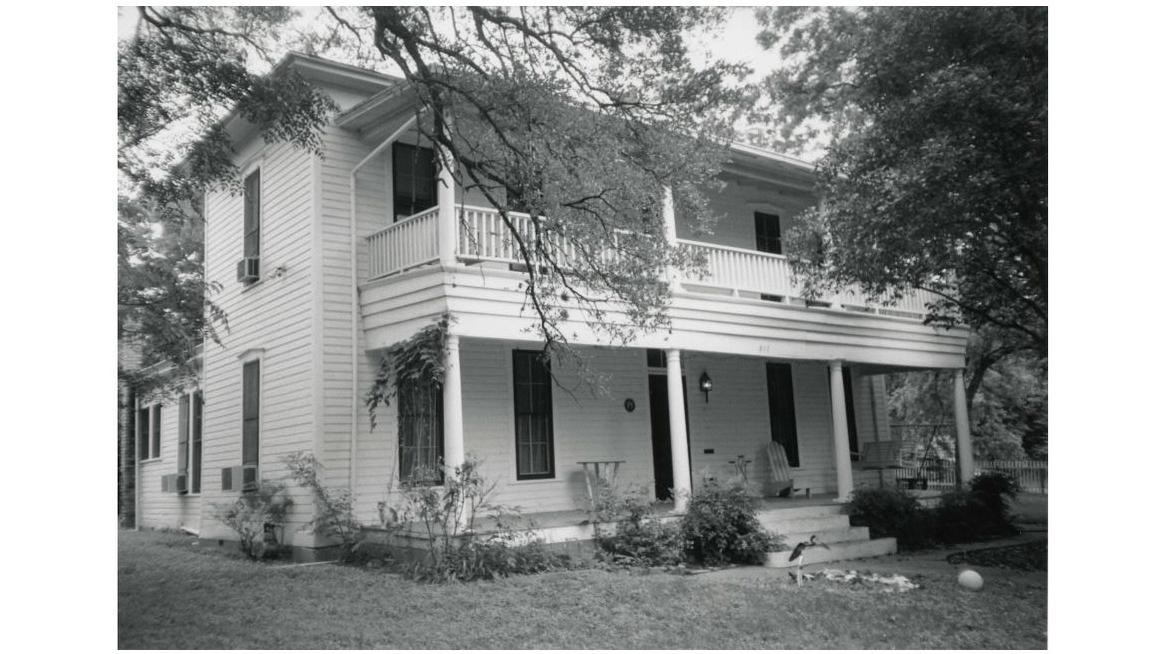 two story house with full length porches on both floors with steps leading up to the entrance 