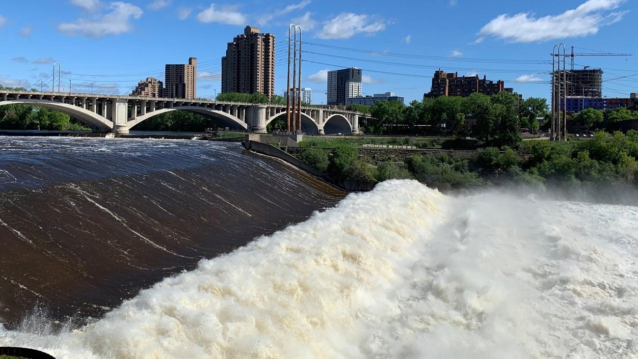 A waterfall pictured next to a lock and dam. 