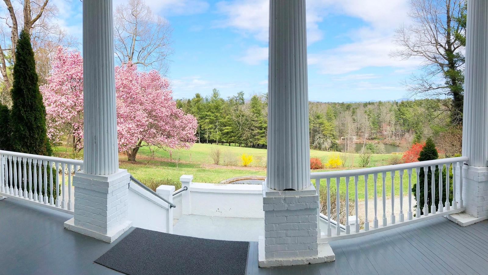 view from the Sandburg porch with 2 tall columns and a mountain view