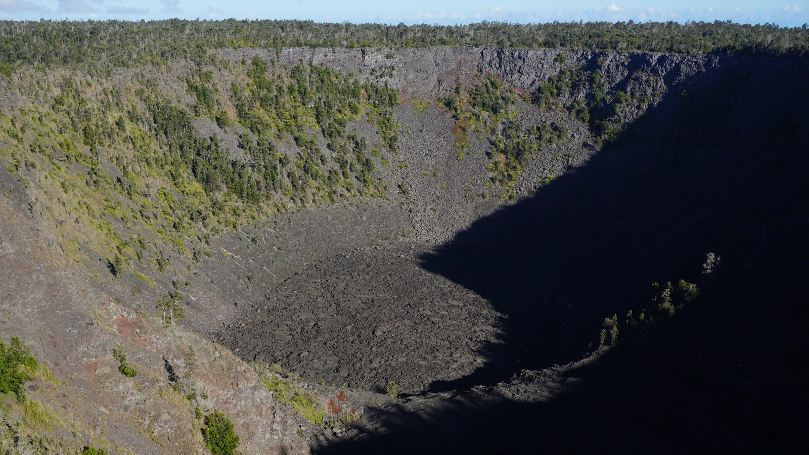 A large volcanic crater with a barren bottom