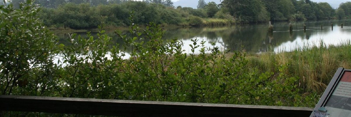 View of the Netul River from the Historic Canoe Landing with a section of a wayside in the corner
