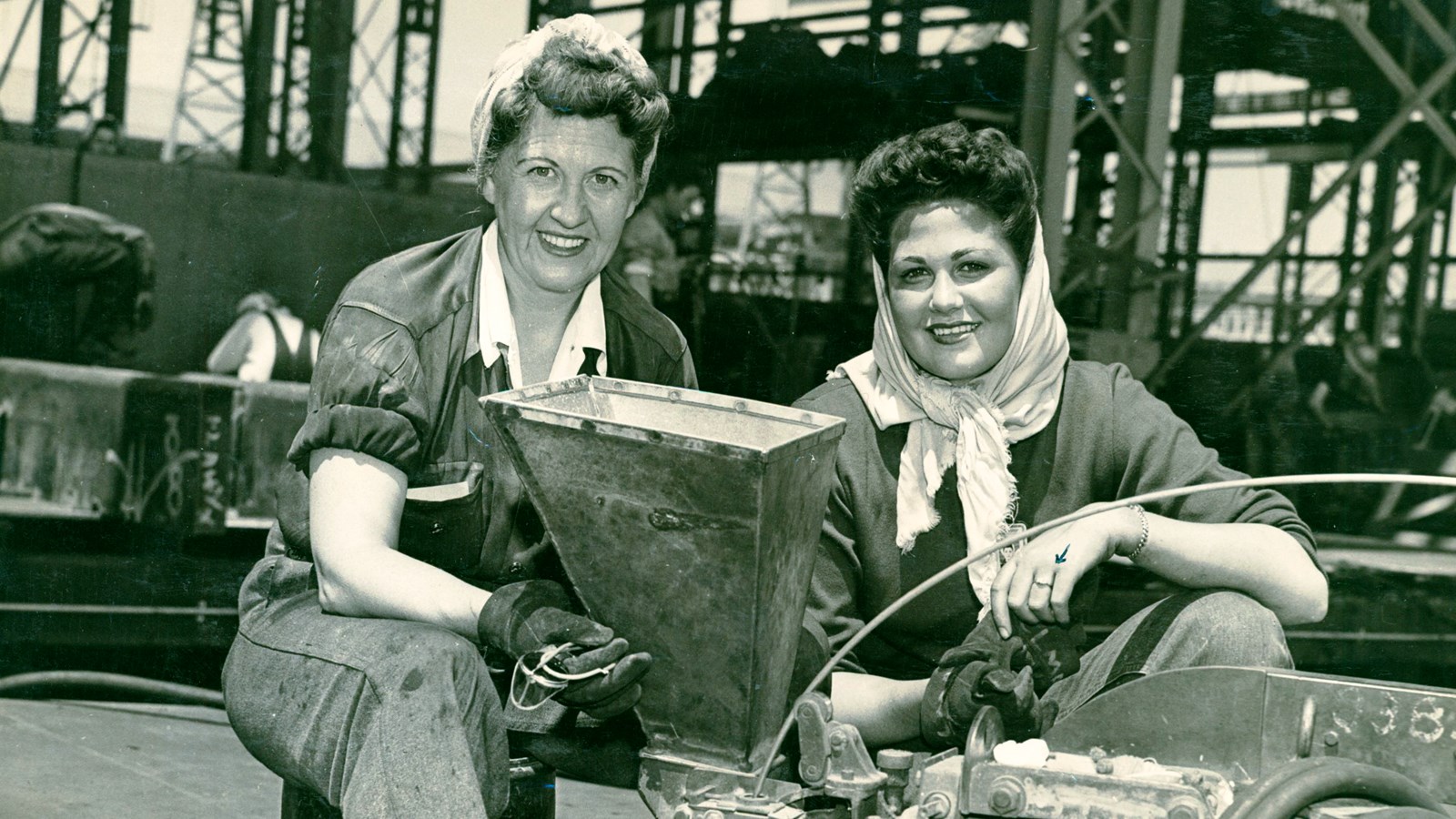 WWII photo of two women workers in the Richmond shipyard, posing for the camera. 