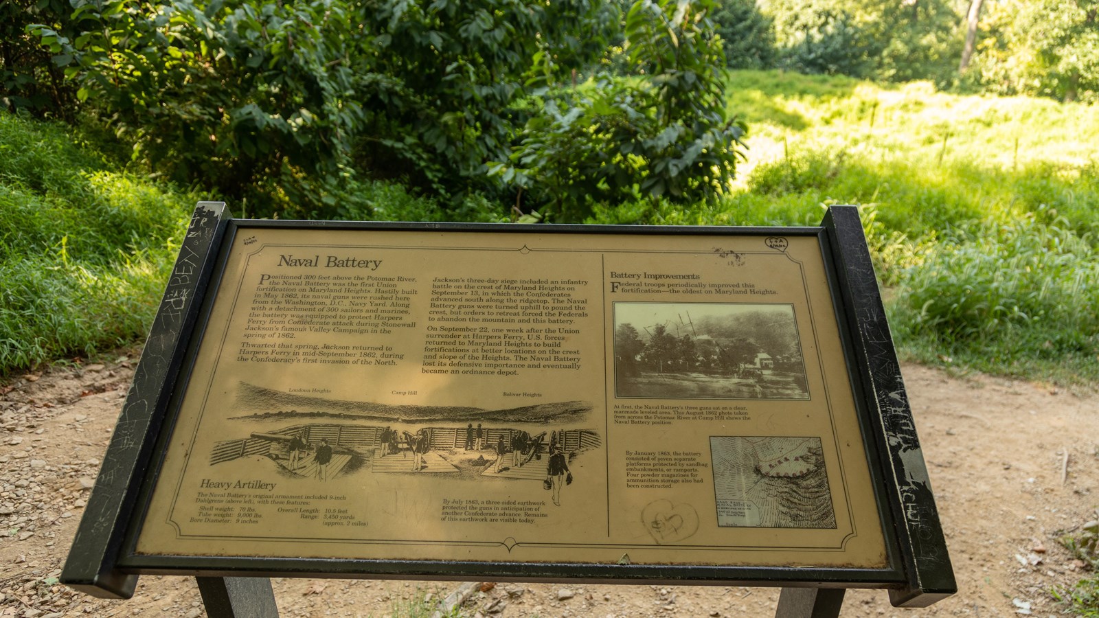 A sign next to a rocky trail describes defensive fortifications built here by the Union Army in 1862