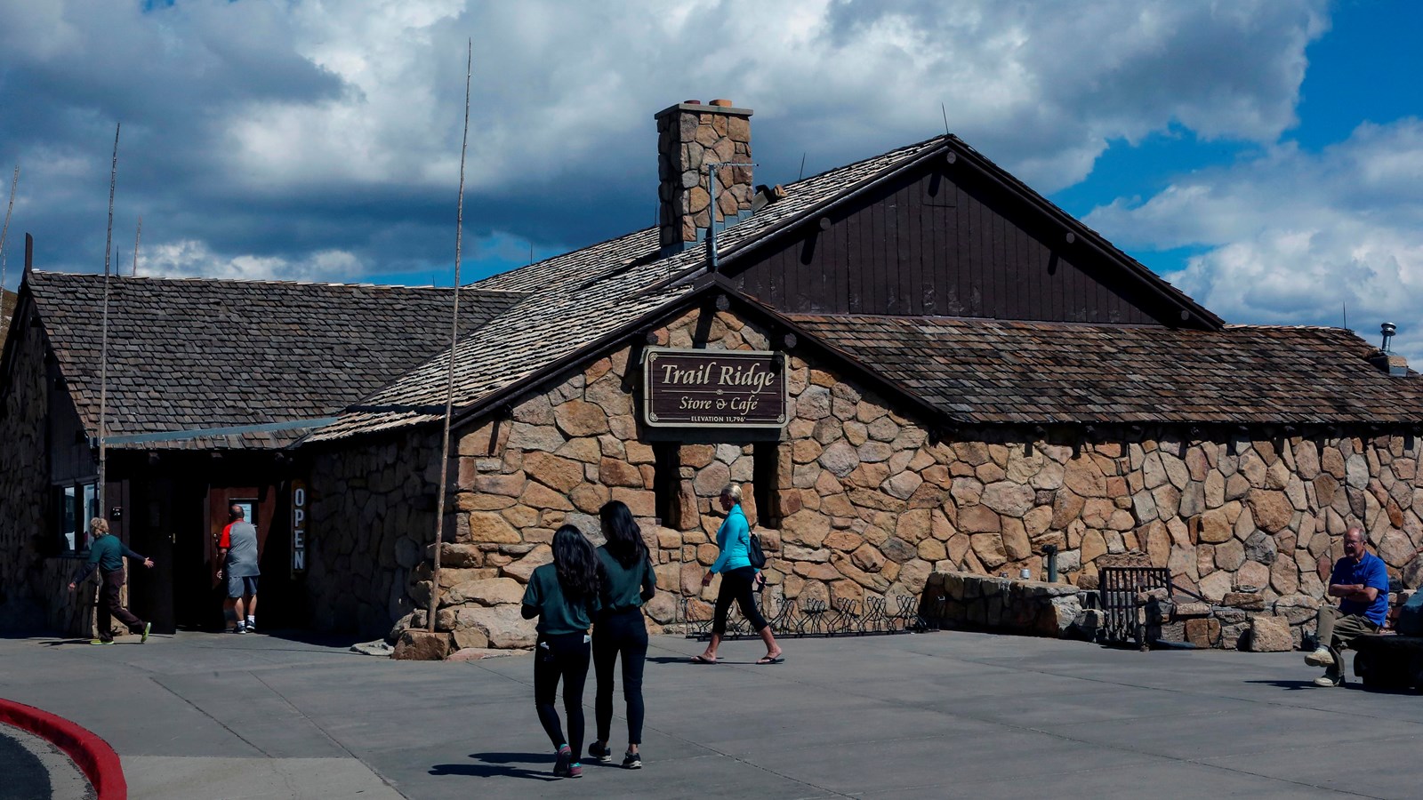 a rocky faced building with shingled roof