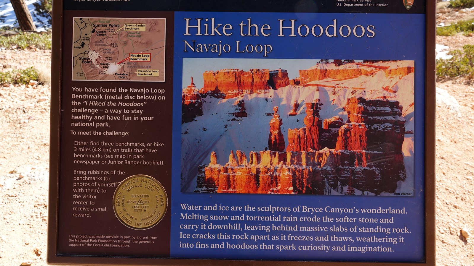 A wayside showing a tall red rock spire describes hoodoos and the Hike the Hoodoos program