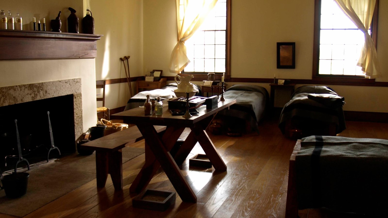 beds and table in front of two windows