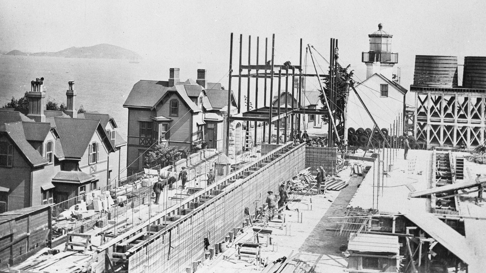 Black and white photograph of men working on the construction of the new prison.