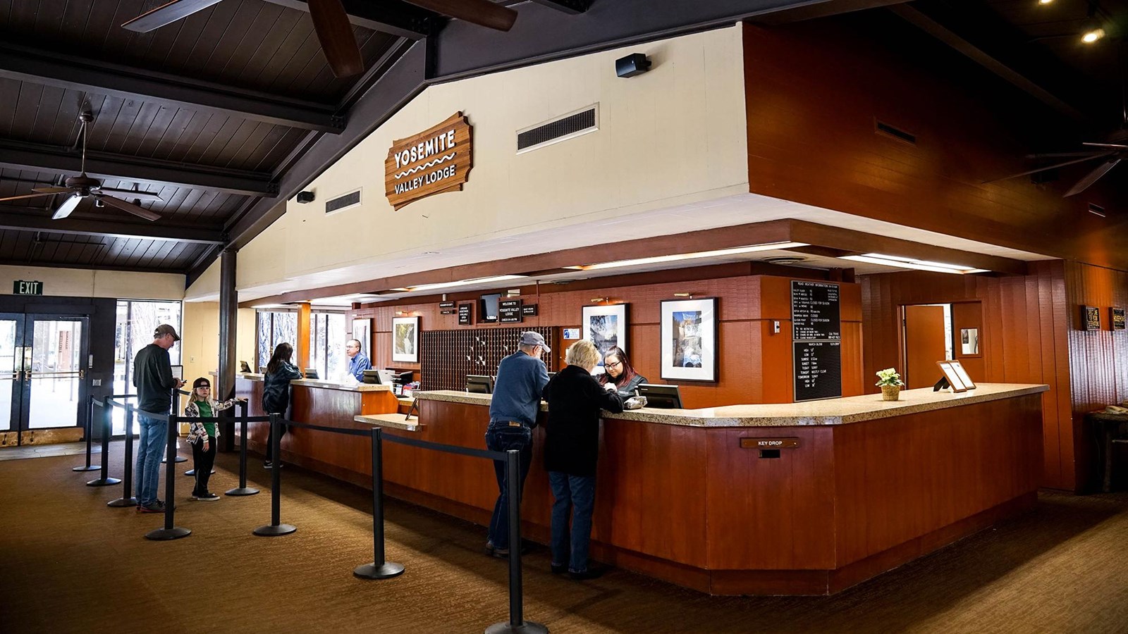 front desk of hotel with visitors checking in