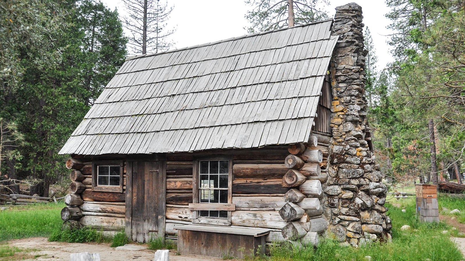 Wooden cabin with rock chimney