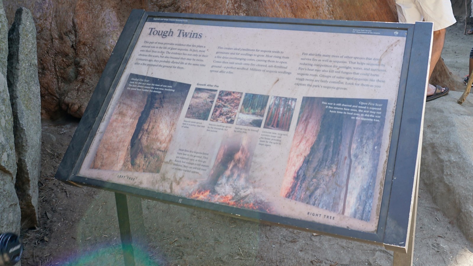 A metal panel sits in a metal frame. On the panel are images and text 