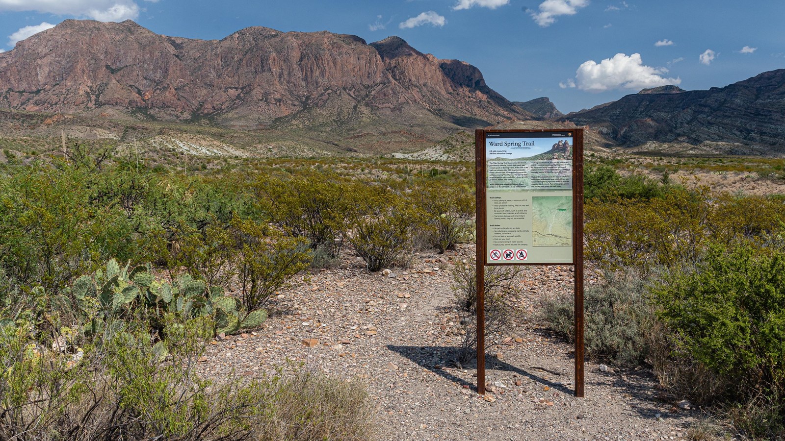 A sign with information about the Ward Spring Trail marks the beginning of the trail.