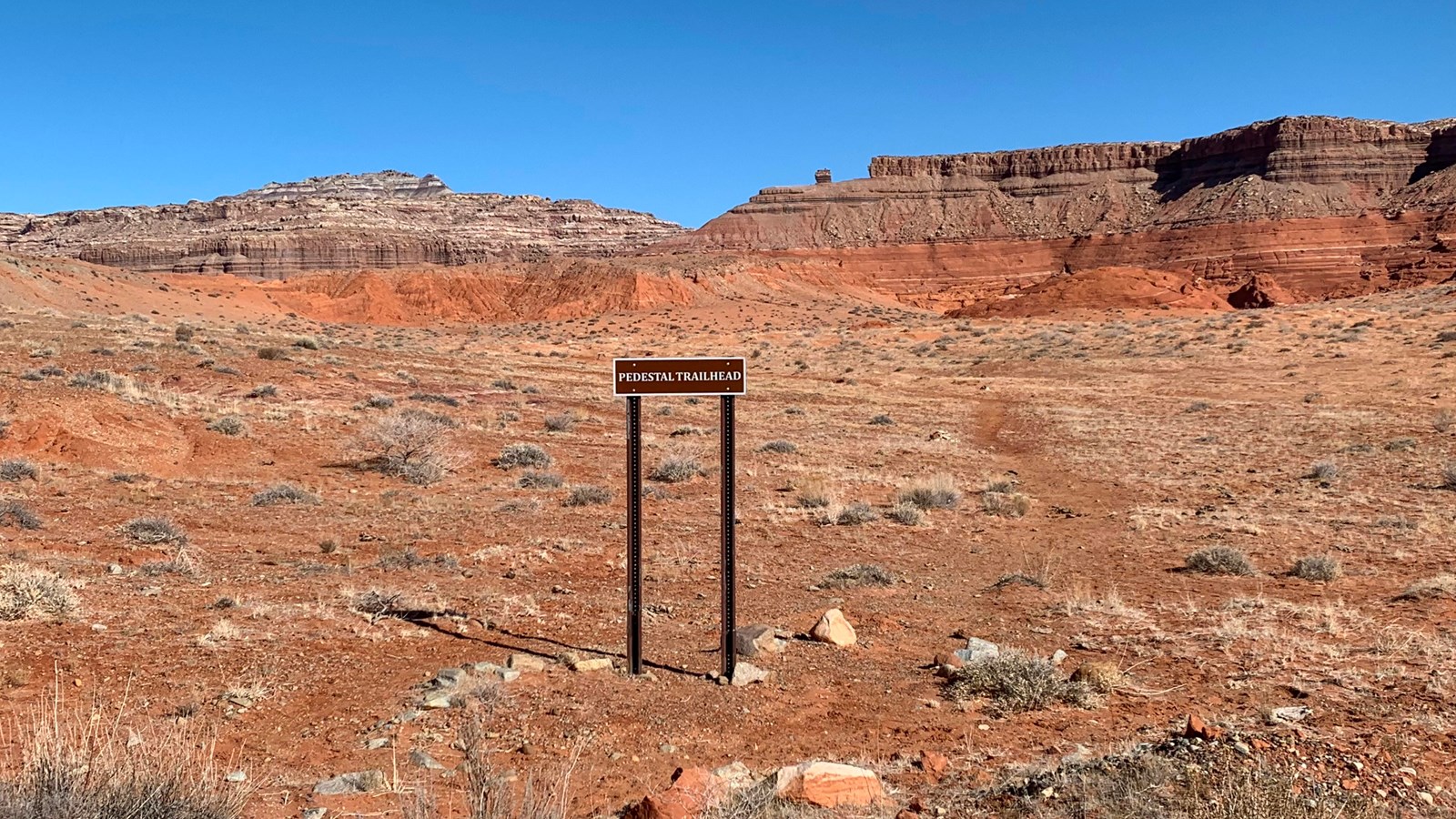 desert landscape, brown sign: pedestal trailhead