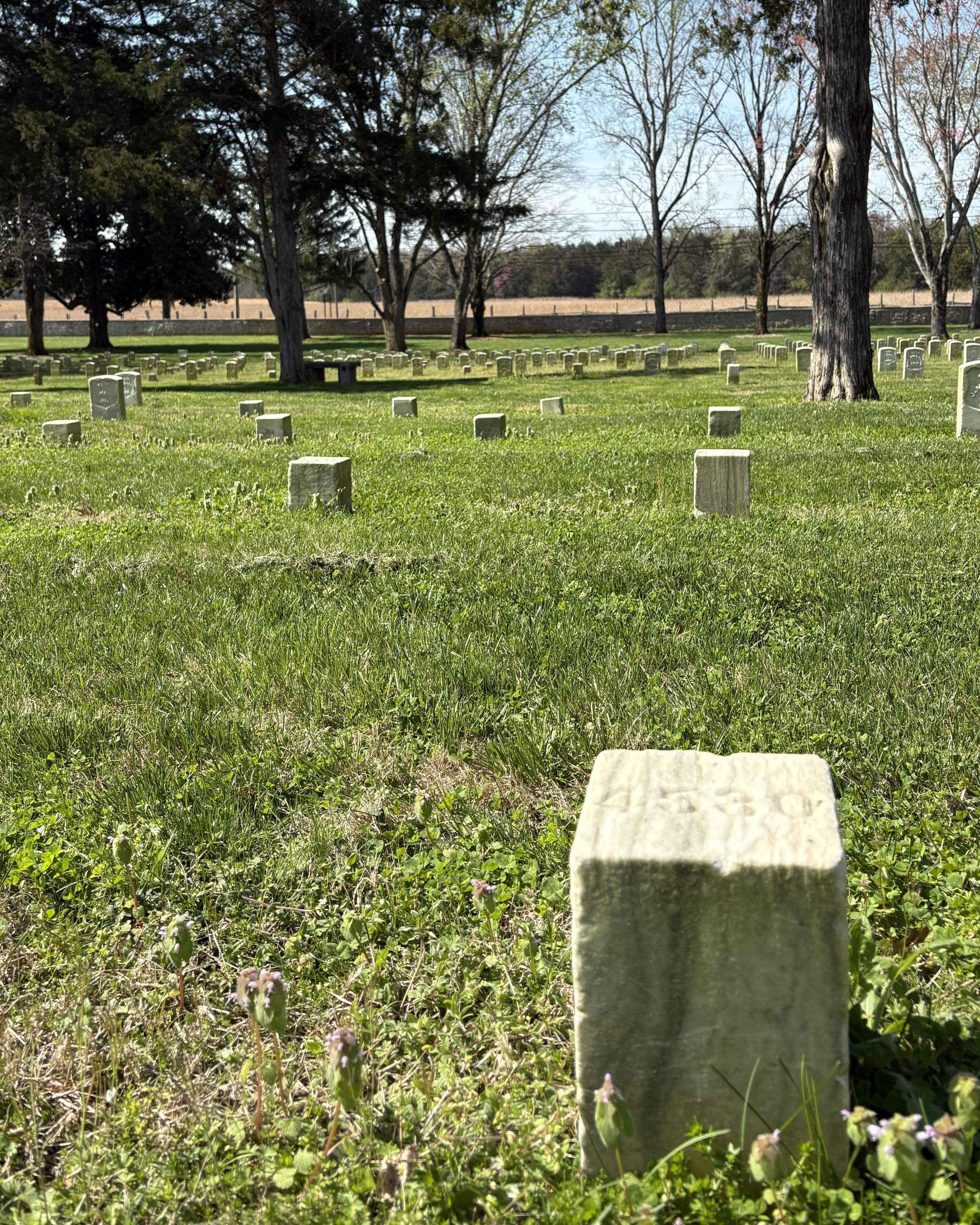 Short, square stone with others behind it. 