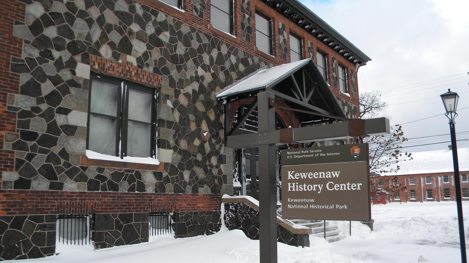 two-story stone and brick building along sidewalk