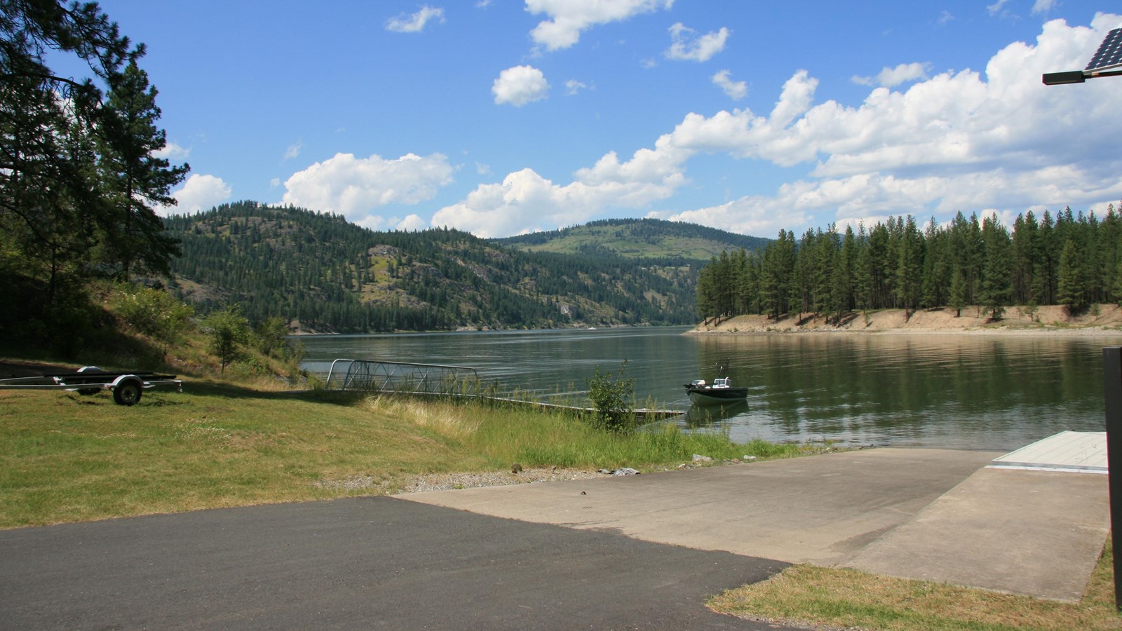 A view of the paved boat launch, dock, and paved access road.